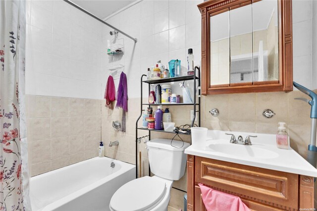 full bathroom with vanity, shower / bath combo, toilet, tile walls, and tasteful backsplash