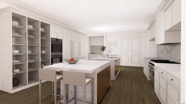 kitchen with tasteful backsplash, white cabinetry, a center island with sink, and appliances with stainless steel finishes