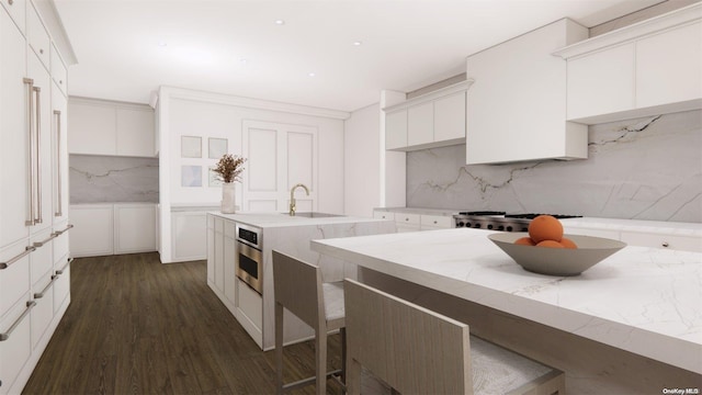 kitchen featuring decorative backsplash, dark hardwood / wood-style floors, white cabinetry, and sink