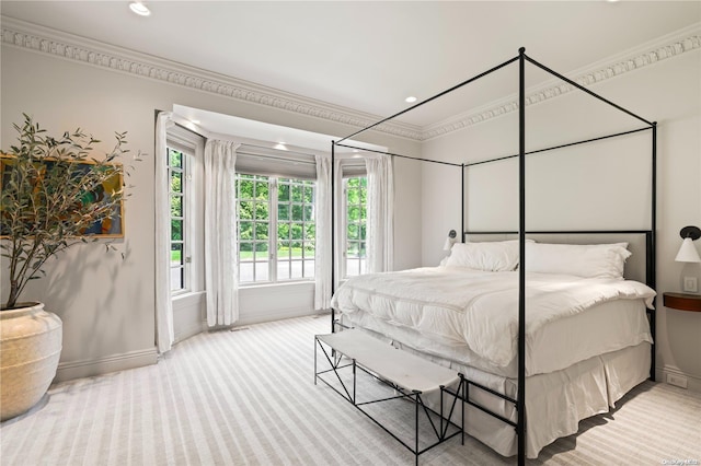 bedroom with crown molding and light colored carpet