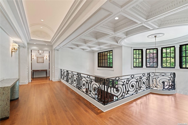 corridor with hardwood / wood-style flooring, crown molding, beamed ceiling, and coffered ceiling