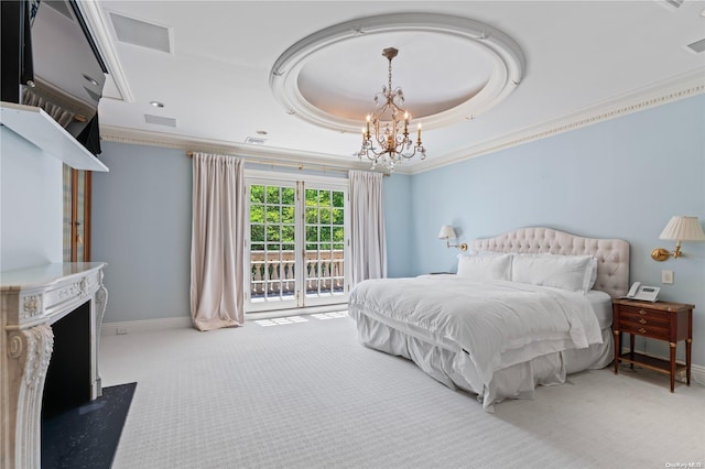 bedroom with carpet, a raised ceiling, access to outside, and an inviting chandelier