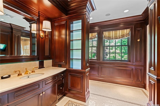 bathroom with vanity, crown molding, and wooden walls