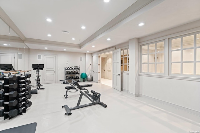 exercise area with a tray ceiling