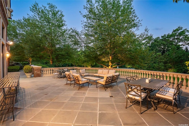 patio terrace at dusk featuring an outdoor hangout area