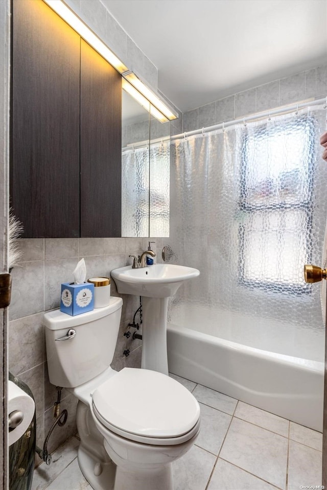 bathroom with tile patterned flooring, shower / bath combination with curtain, tile walls, and toilet