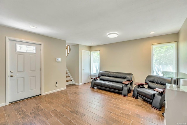 foyer entrance with a wealth of natural light and light hardwood / wood-style floors