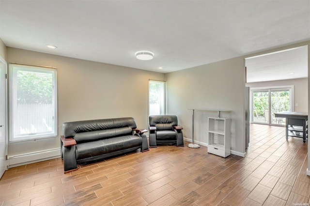 living room featuring baseboard heating and light hardwood / wood-style flooring