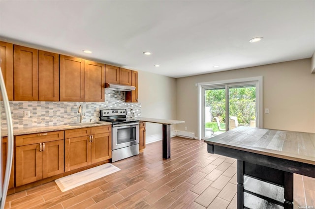 kitchen featuring stainless steel electric range oven, sink, baseboard heating, light hardwood / wood-style flooring, and backsplash