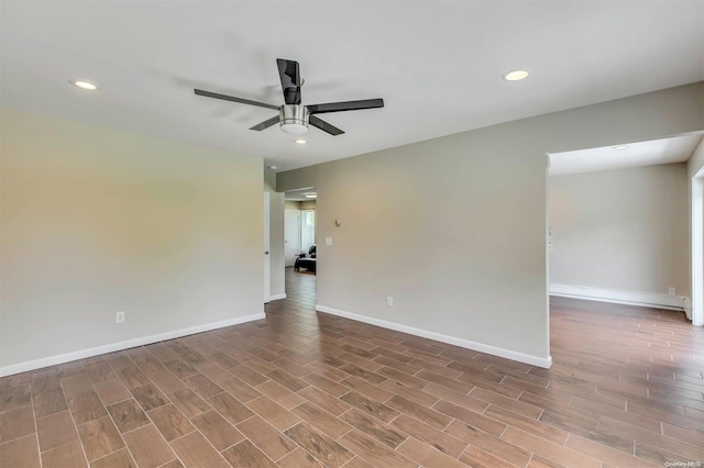 spare room with hardwood / wood-style floors and ceiling fan