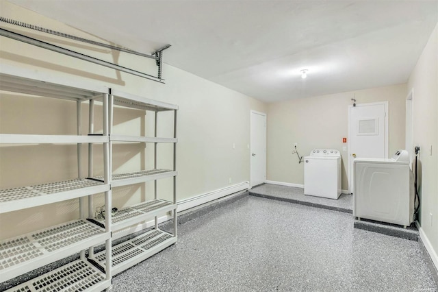 clothes washing area featuring washer and clothes dryer and baseboard heating