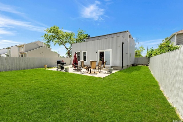 back of house featuring a patio area and a yard