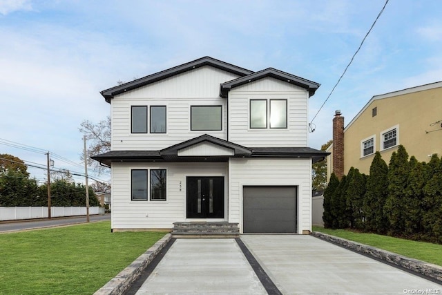 view of front of house with a front yard and a garage