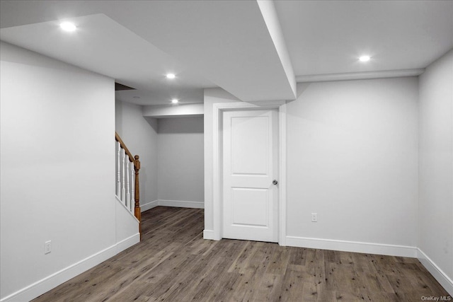 basement with dark hardwood / wood-style floors