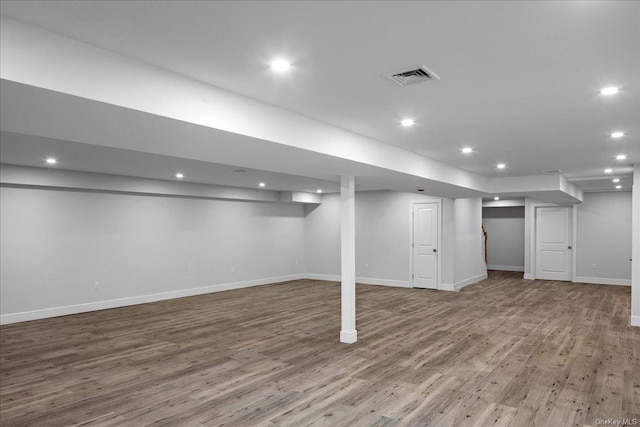 basement with hardwood / wood-style flooring