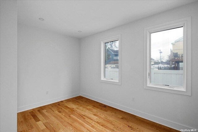 unfurnished room with light wood-type flooring