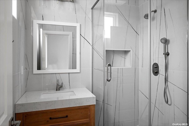 bathroom featuring vanity and a shower with shower door