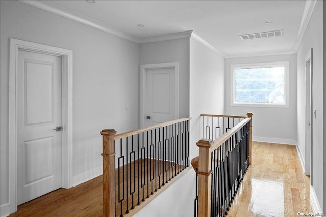 hall featuring crown molding and light wood-type flooring