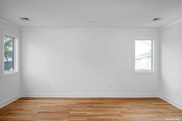 spare room with light hardwood / wood-style floors and ornamental molding