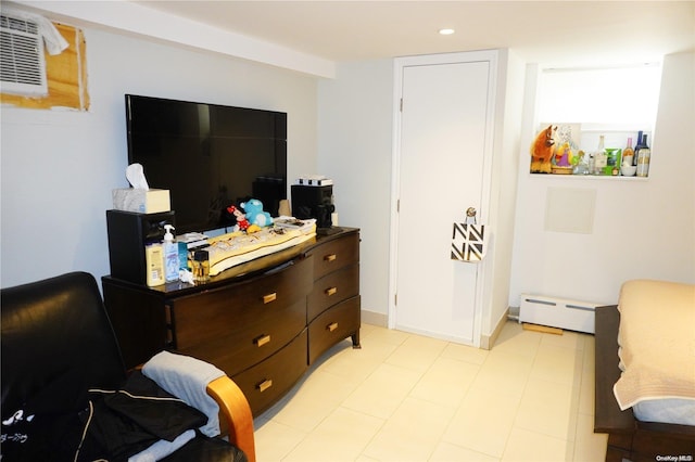 bedroom featuring baseboard heating and a wall unit AC