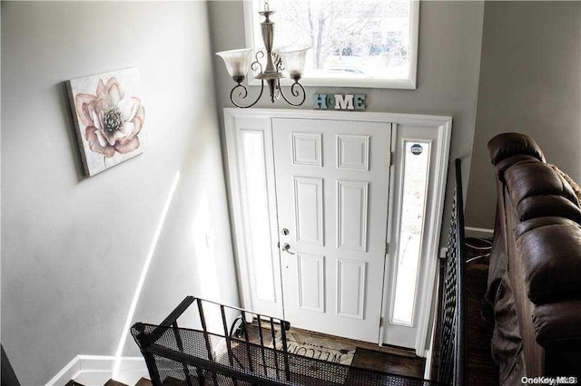 entrance foyer featuring a notable chandelier and a wealth of natural light