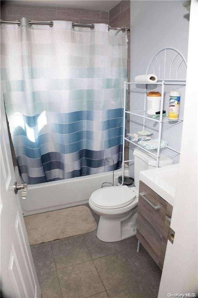 full bathroom featuring tile patterned flooring, shower / bath combination with curtain, vanity, and toilet