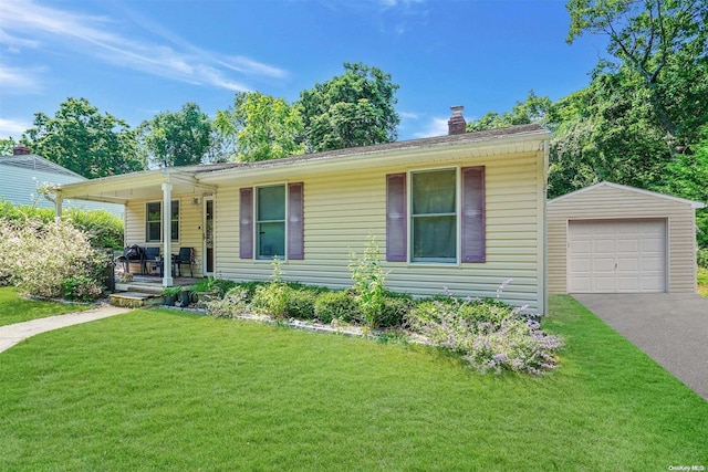 view of front of house with covered porch, a garage, a front lawn, and an outdoor structure