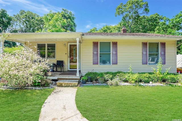 ranch-style house featuring a porch and a front lawn