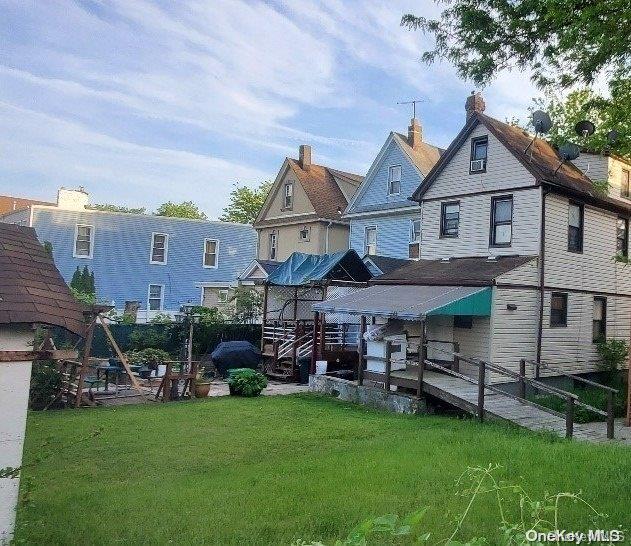 rear view of house with a yard