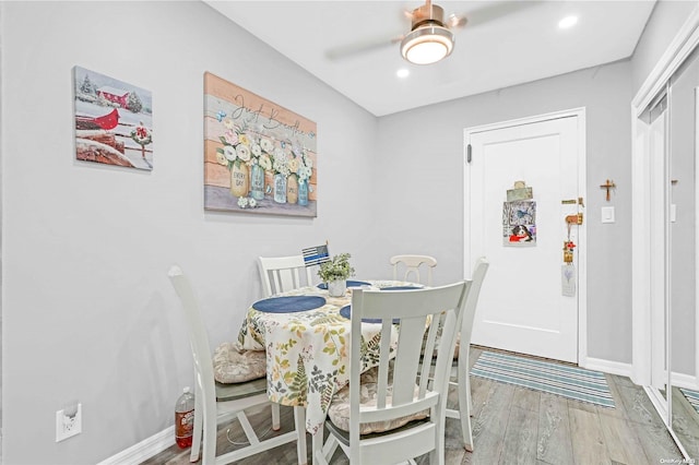 dining room with ceiling fan and hardwood / wood-style flooring