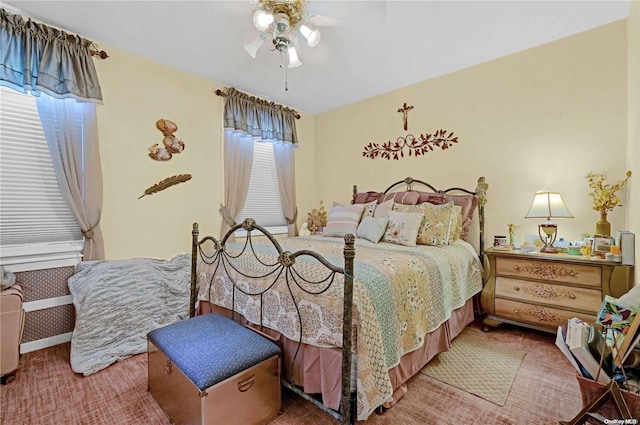 carpeted bedroom with ceiling fan and multiple windows