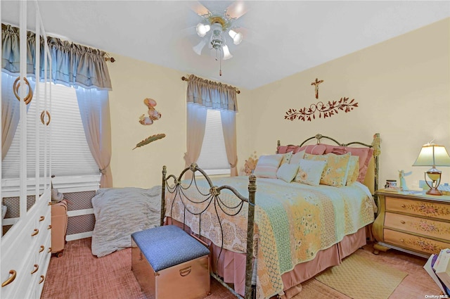 bedroom with multiple windows and ceiling fan