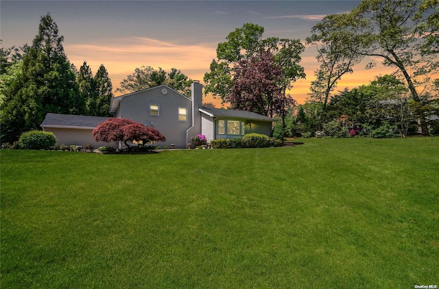 view of yard at dusk