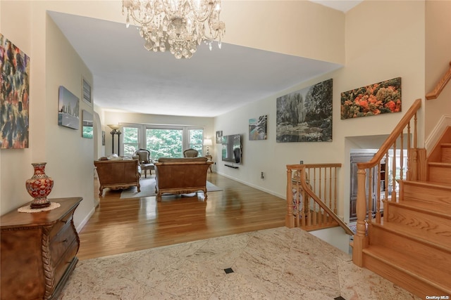 hallway with wood-type flooring and a notable chandelier