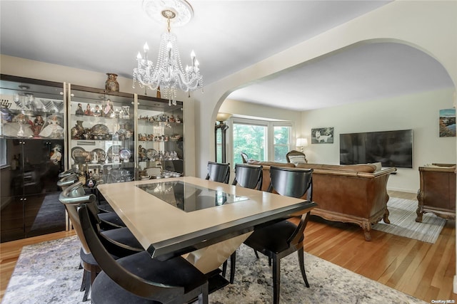 dining room featuring hardwood / wood-style flooring and a chandelier