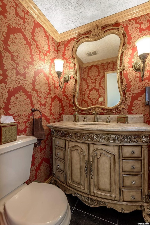 bathroom with vanity, a textured ceiling, and toilet