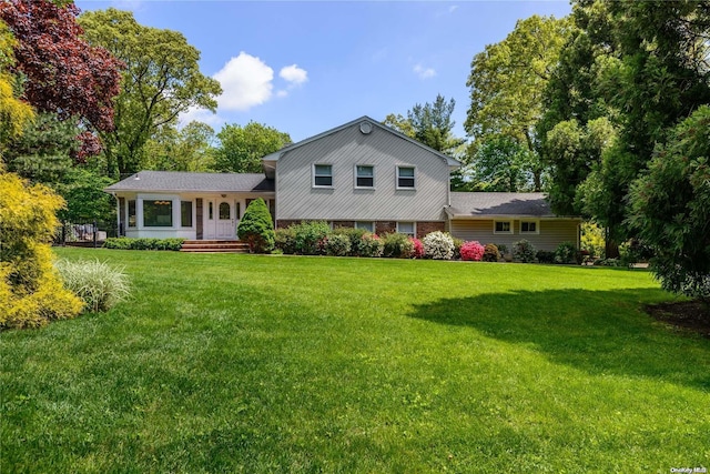 back of property featuring a lawn
