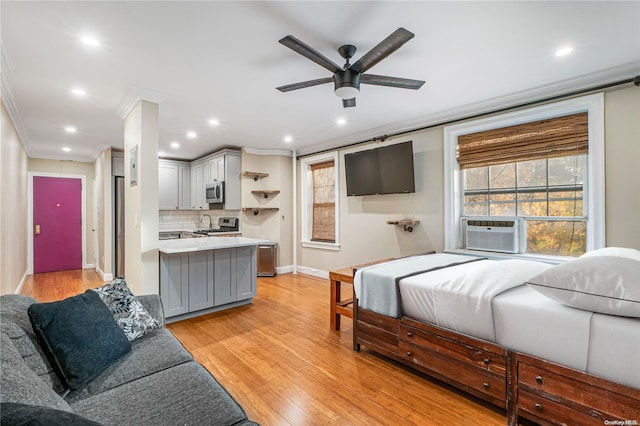 bedroom featuring ceiling fan, cooling unit, light wood-type flooring, and crown molding