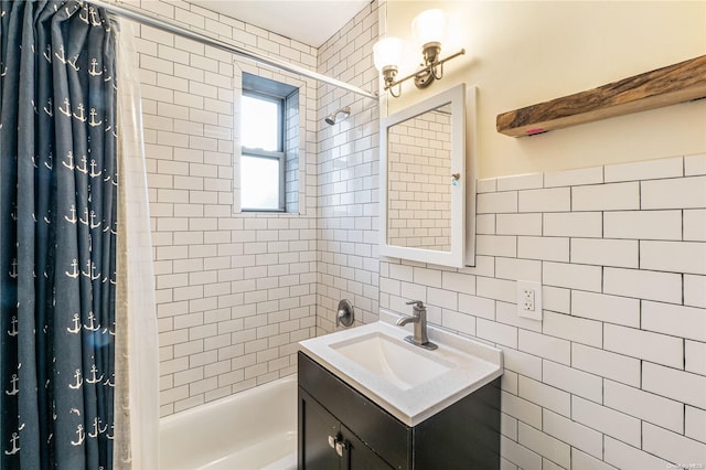 bathroom with shower / bath combo, tile walls, and vanity