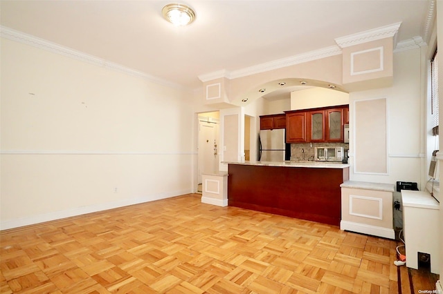 kitchen with kitchen peninsula, light parquet floors, stainless steel refrigerator, and crown molding