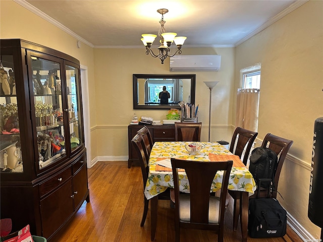 dining room featuring a chandelier, light hardwood / wood-style floors, crown molding, and a wall mounted AC