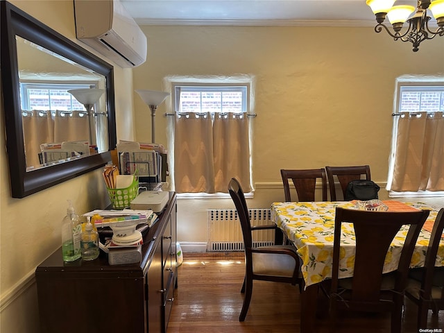 dining space with radiator, an inviting chandelier, an AC wall unit, ornamental molding, and dark hardwood / wood-style flooring