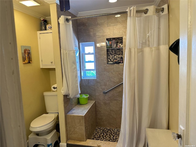 bathroom with a shower with shower curtain, toilet, and crown molding