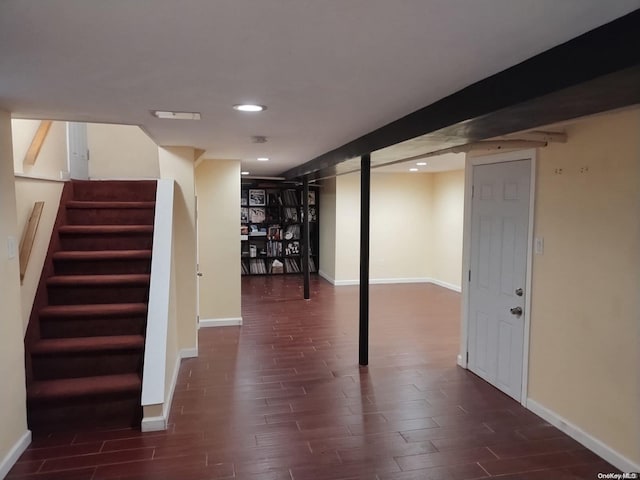 basement with dark hardwood / wood-style flooring