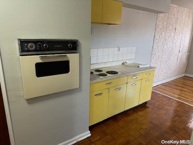 kitchen featuring dark parquet floors and white appliances