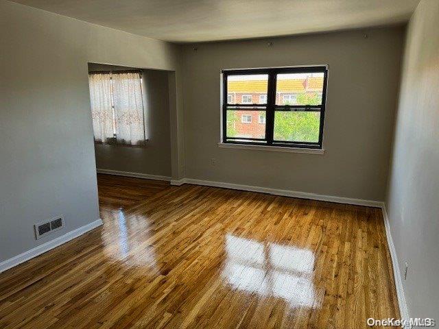 unfurnished room with hardwood / wood-style floors