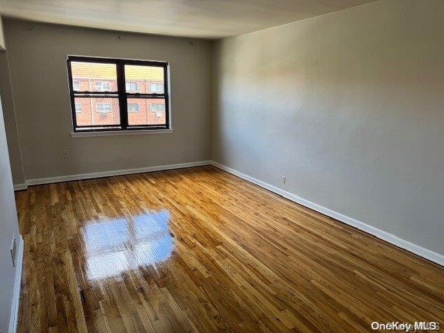 spare room with hardwood / wood-style flooring