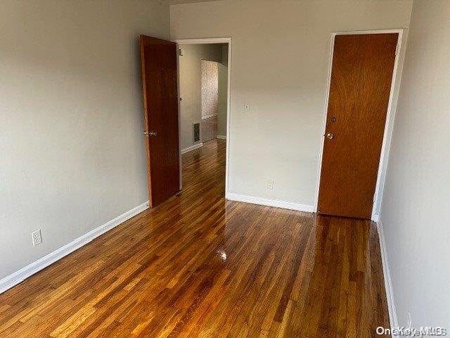 spare room with dark hardwood / wood-style flooring