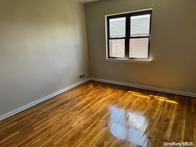 spare room with hardwood / wood-style floors