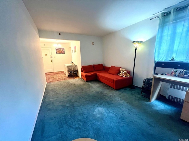 living room with radiator heating unit and dark carpet